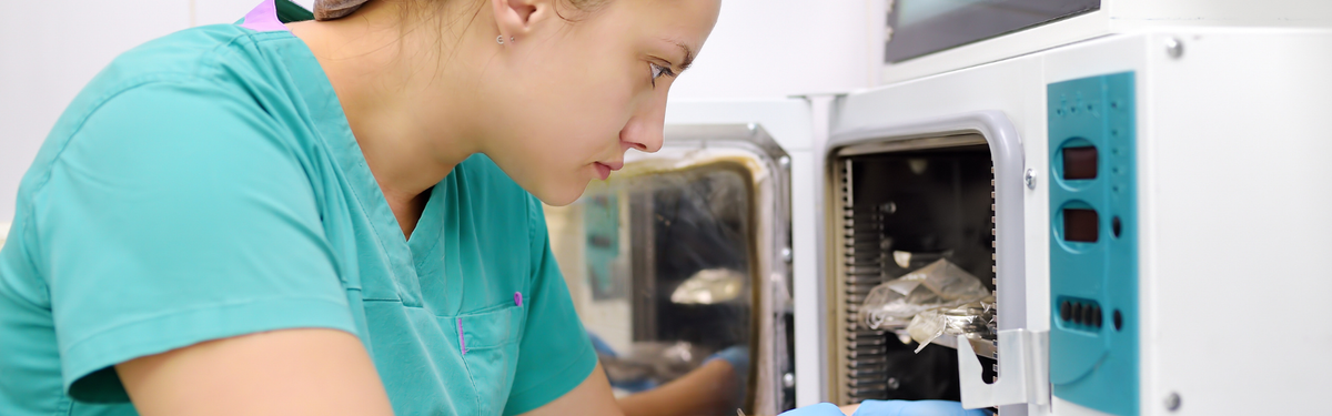 Veterinary nurse using a multi-parameter monitor in a practice theatre.